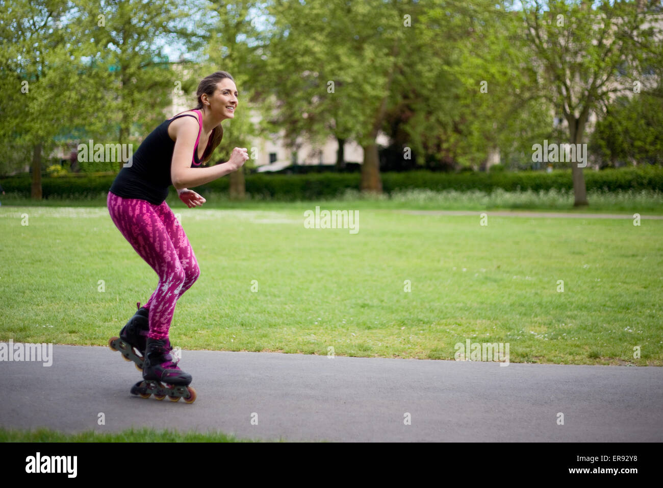 young woman rollerblading in the park Stock Photo