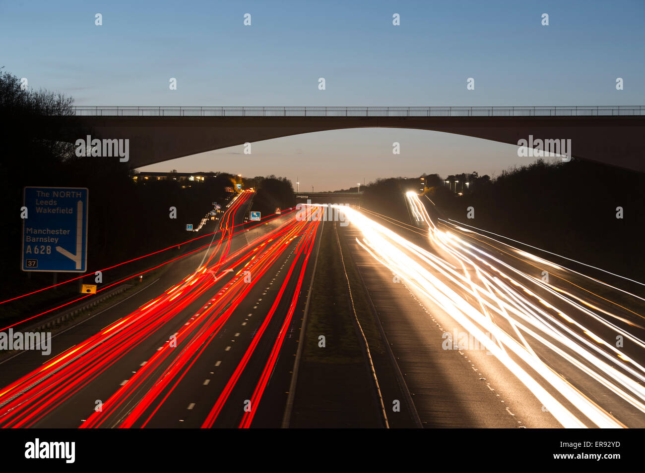 Vehicles travelling along the M1 motorway passing through Barnsley in South Yorkshire at dusk Stock Photo