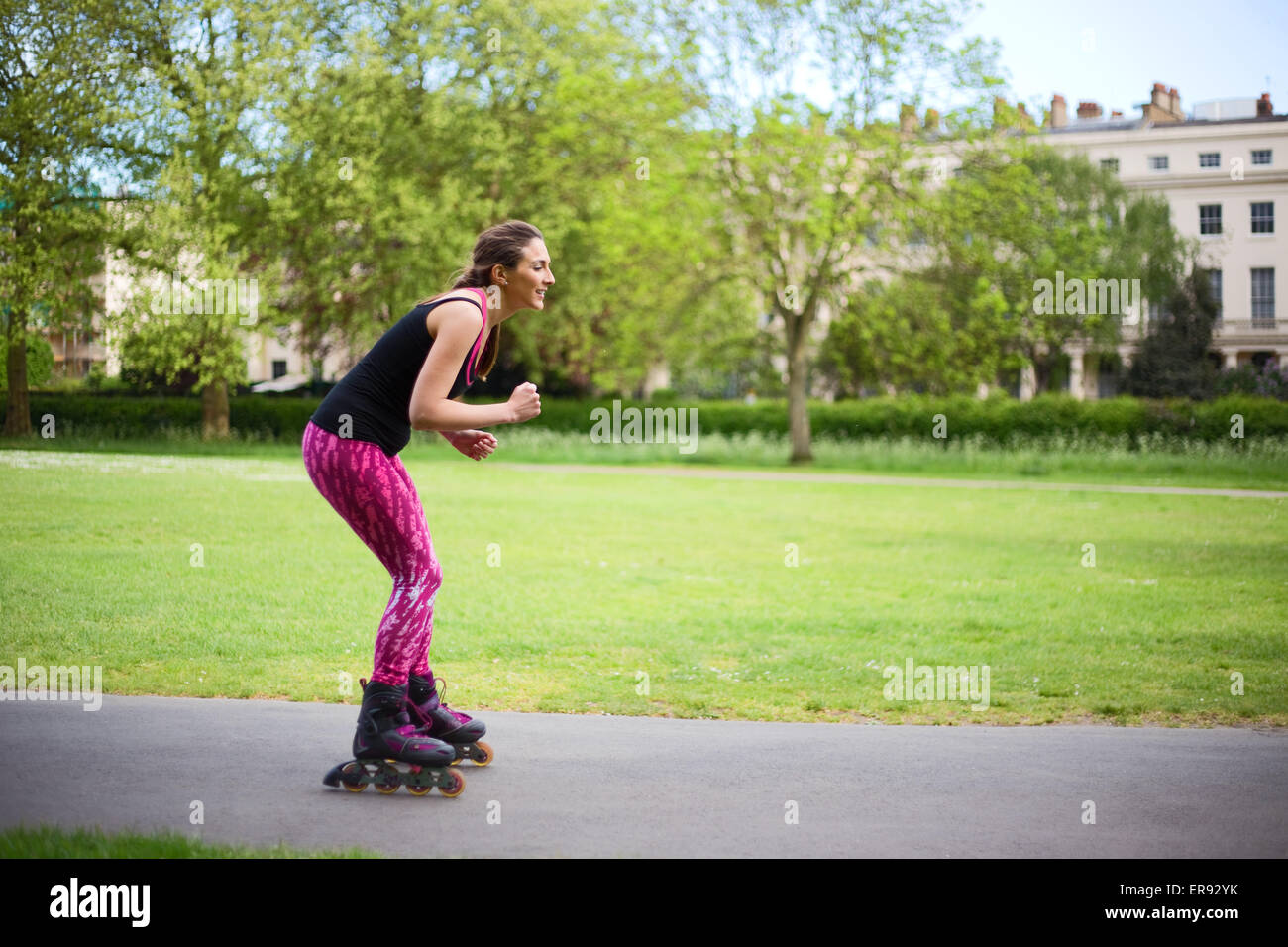 young woman rollerblading in the park Stock Photo