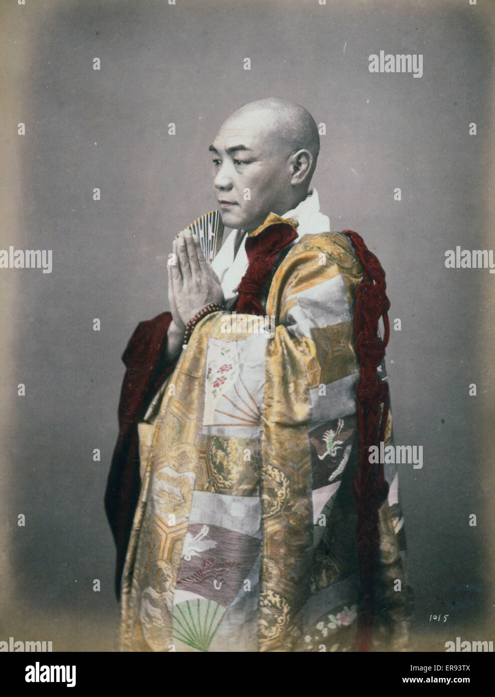 Monk, three-quarter length studio portrait, standing, facing Stock Photo