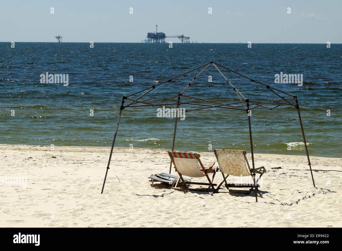 Frame of canopy sits over a pair of chaise lounges on the beach of the Gulf of Mexico on the Fort Morgan peninsula. Stock Photo