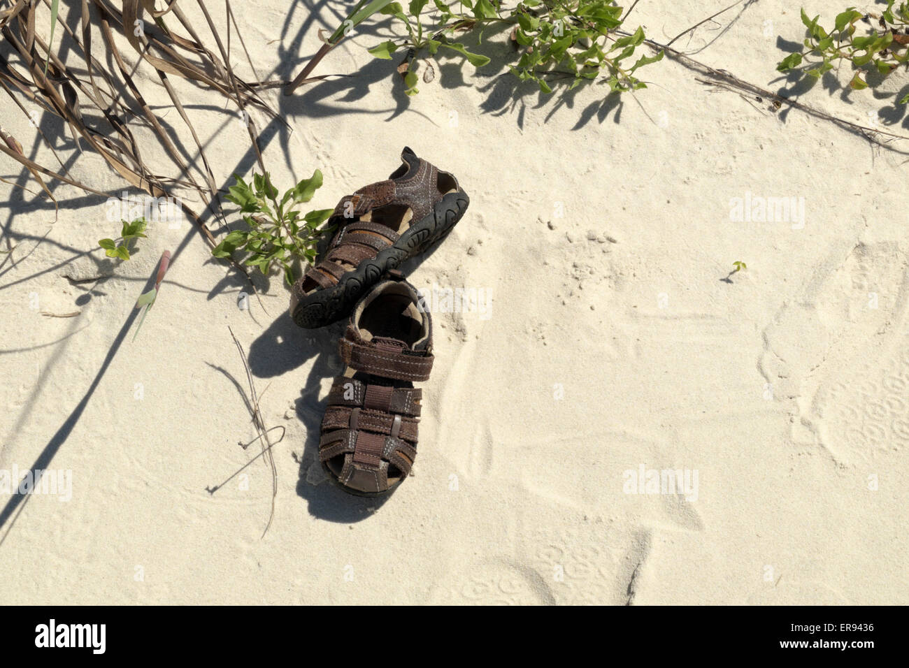 Little boy's lost sandals on the Gulf of Mexico beach at Gulf Shores, Alabama. Stock Photo