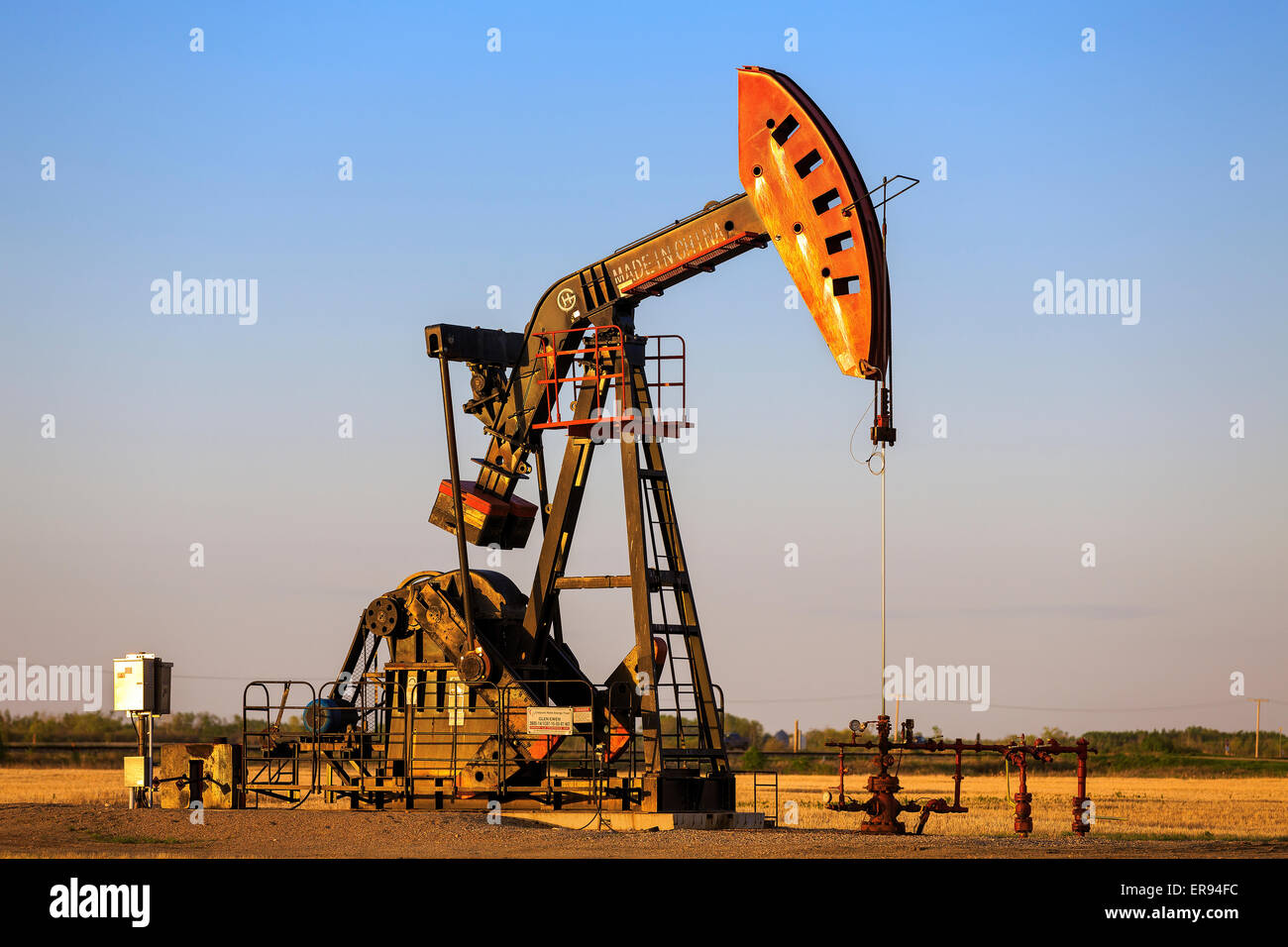 Oil well pump jack in the Bakken Oil Field, near Estevan, Saskatchewan, Canada Stock Photo