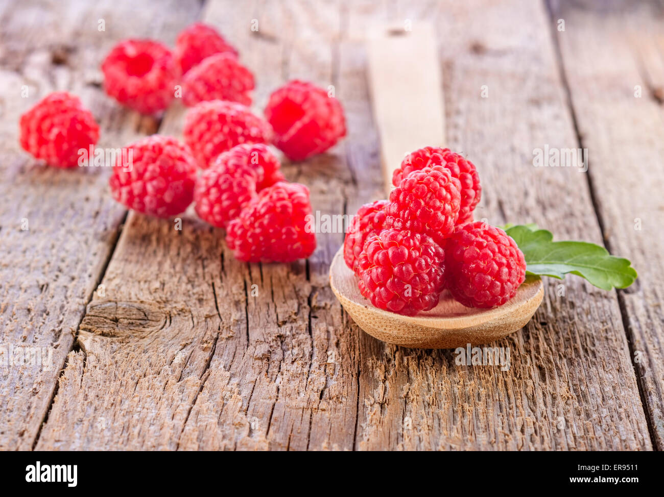 fresh raspberry in wooden spoon on wooden table Stock Photo