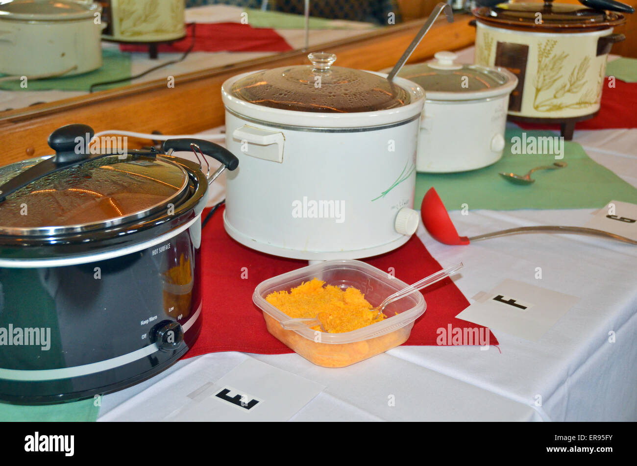 Row of crock pots for a chili cook-off in a restaurant. Stock Photo