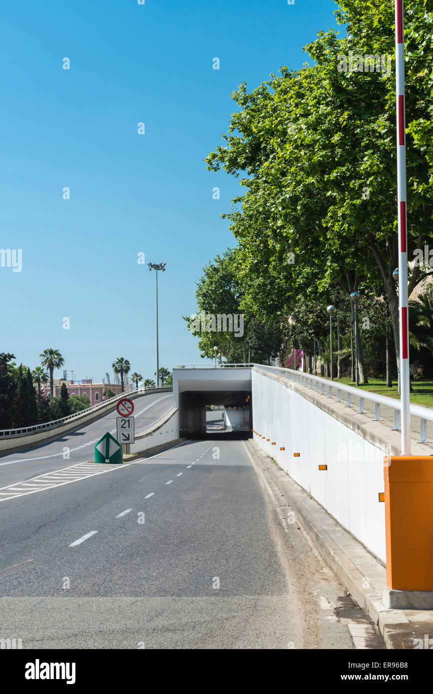 Road with raised barrier under a tunnel in Barcelona, Catalonia, Spain Stock Photo