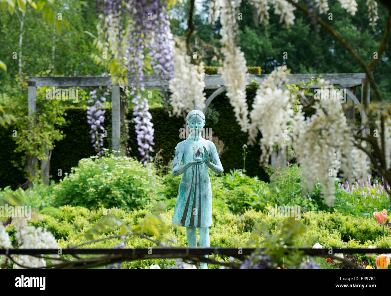 Girl statue called the 'lamp of wisdom'. Ornamental garden statue and