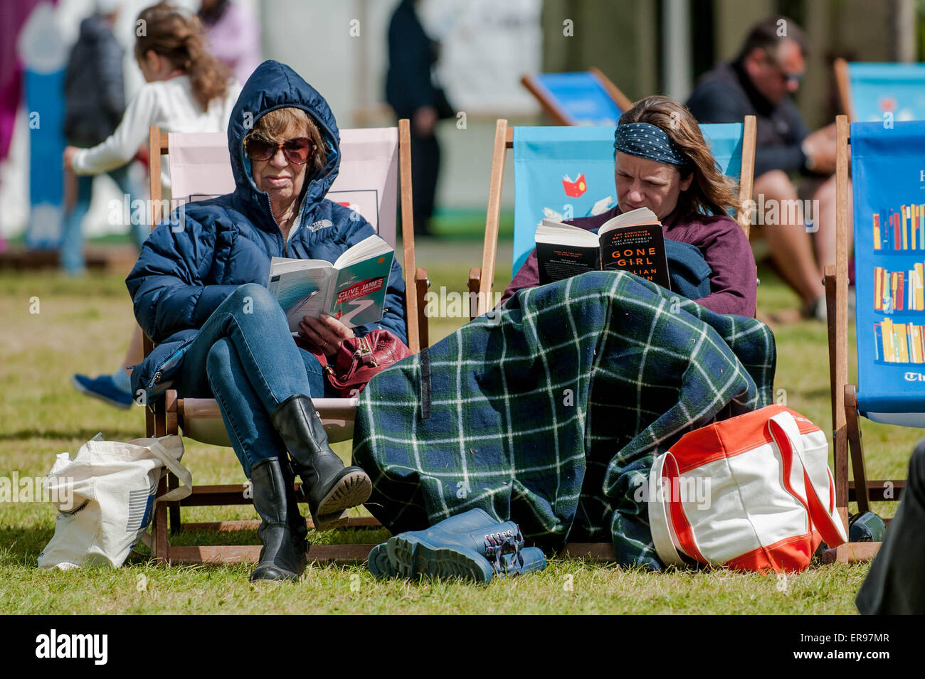 Hay on Wye, UK. Thursday 28 May 2015  Pictured: People wrap up warm to read books at the Hay festival Re: The 2015 Hay Festival takes place in Hay on Wye, Powys, Wales Stock Photo