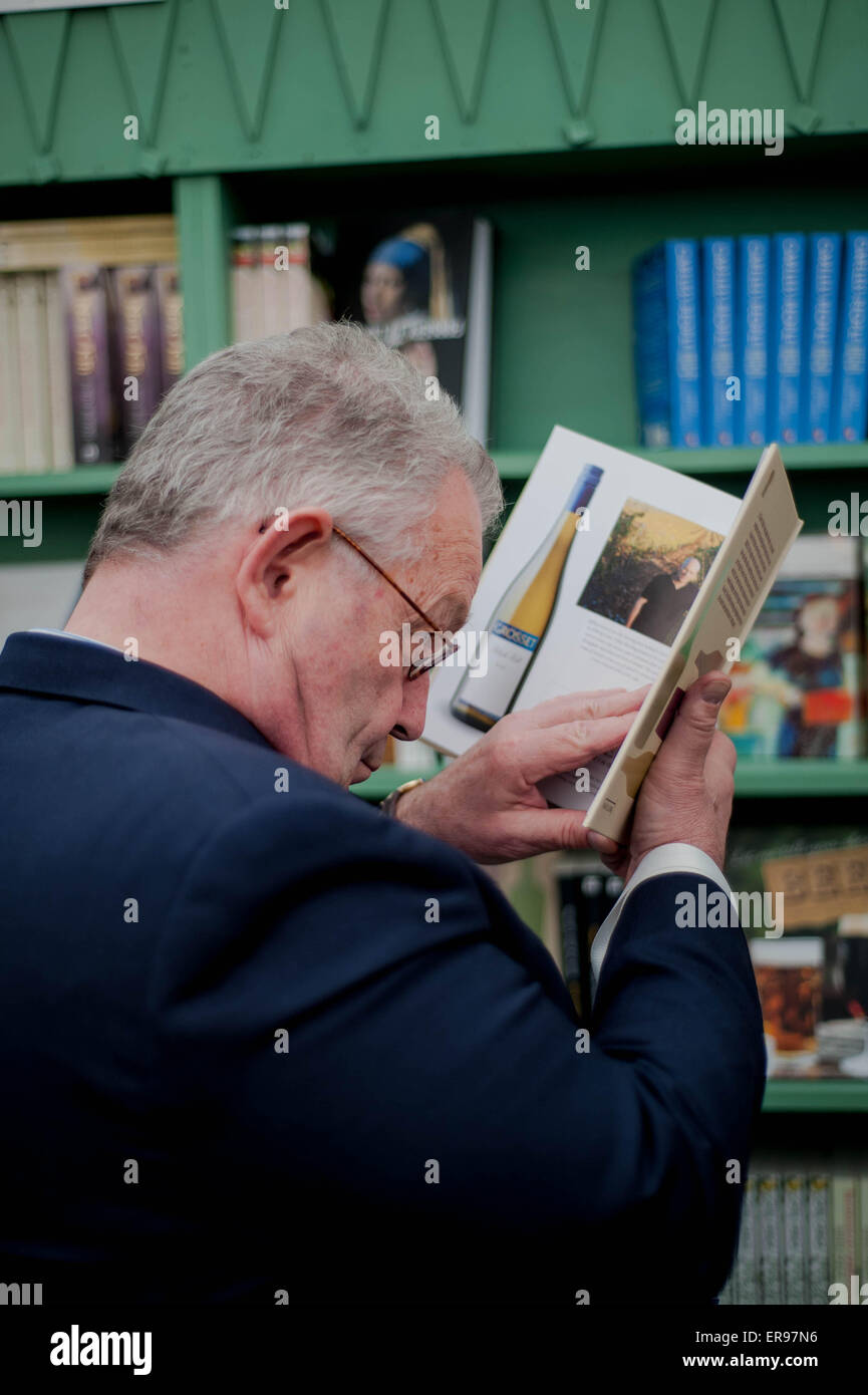 Hay on Wye, UK. Thursday 28 May 2015  Pictured: A man studies a book in the book shop at the Hay Festival Re: The 2015 Hay Festival takes place in Hay on Wye, Powys, Wales Stock Photo