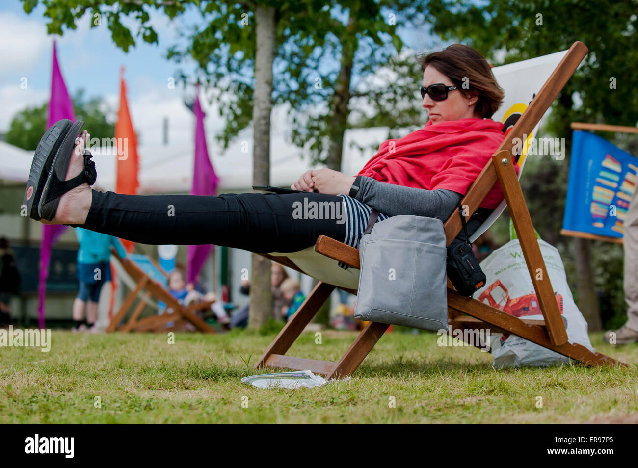 Hay on Wye, UK. Thursday 28 May 2015  Pictured: A woman relaxes in the Sun at the Hay Festival RE: The Hay Festival takes place in Hay on Wye, Powys, Wales Stock Photo