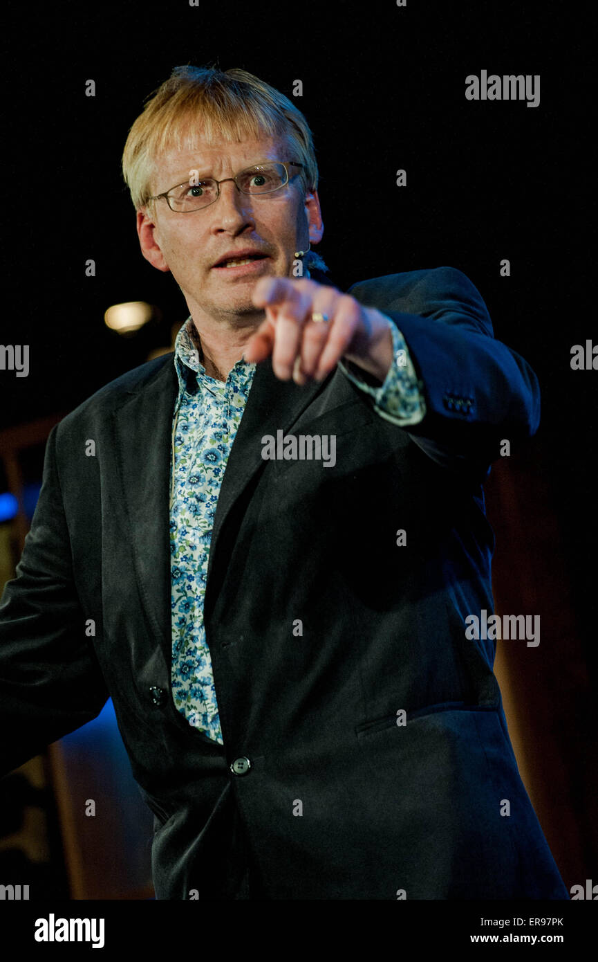 Hay on Wye, UK. Thursday 28 May 2015  Pictured: Dr. Phill Hammond es while reading a book  at the Hay Festival RE: The Hay Festival takes place in Hay on Wye, Powys, Wales Stock Photo