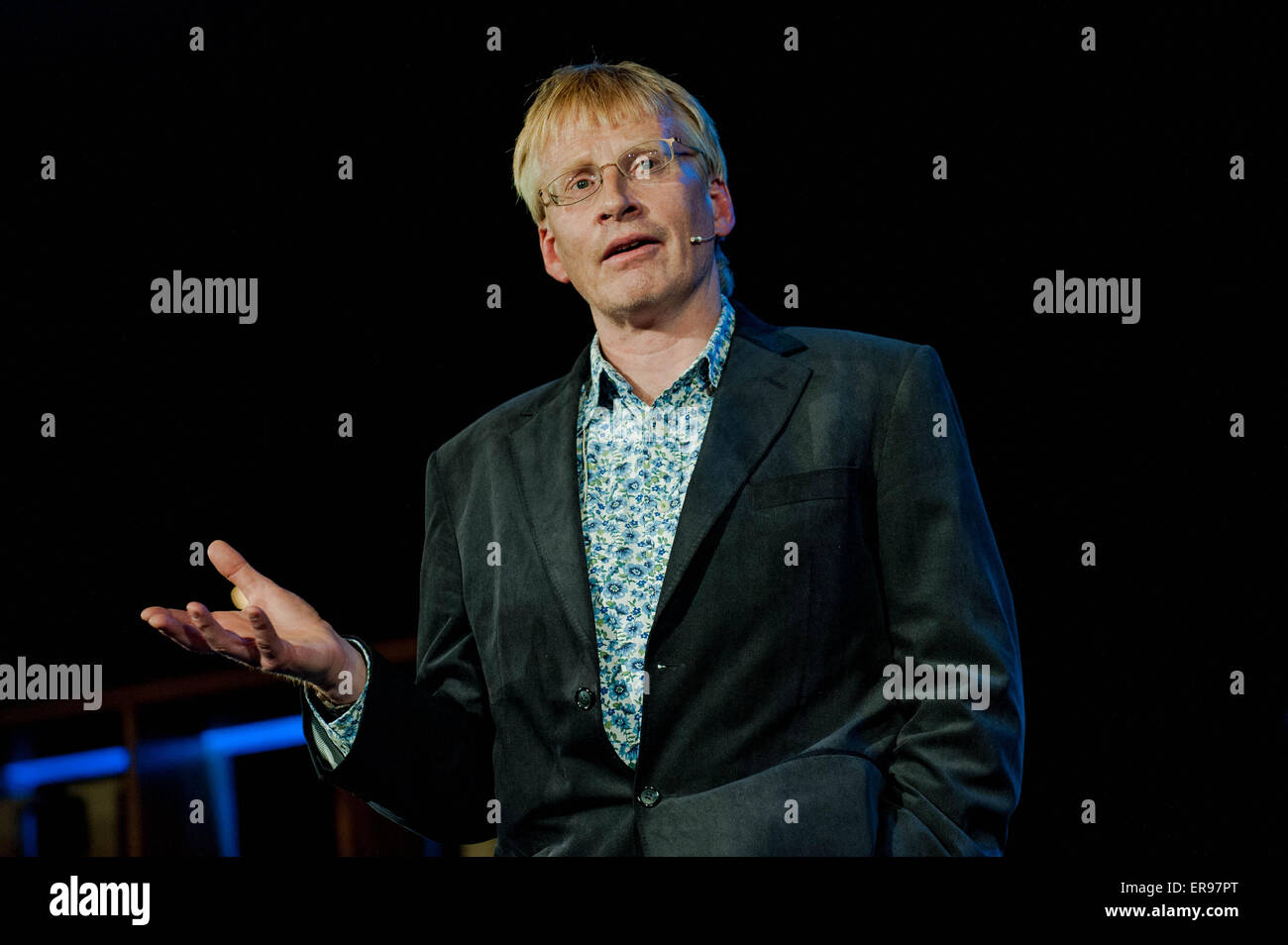 Hay on Wye, UK. Thursday 28 May 2015  Pictured: Dr. Phill Hammond es while reading a book  at the Hay Festival RE: The Hay Festival takes place in Hay on Wye, Powys, Wales Stock Photo
