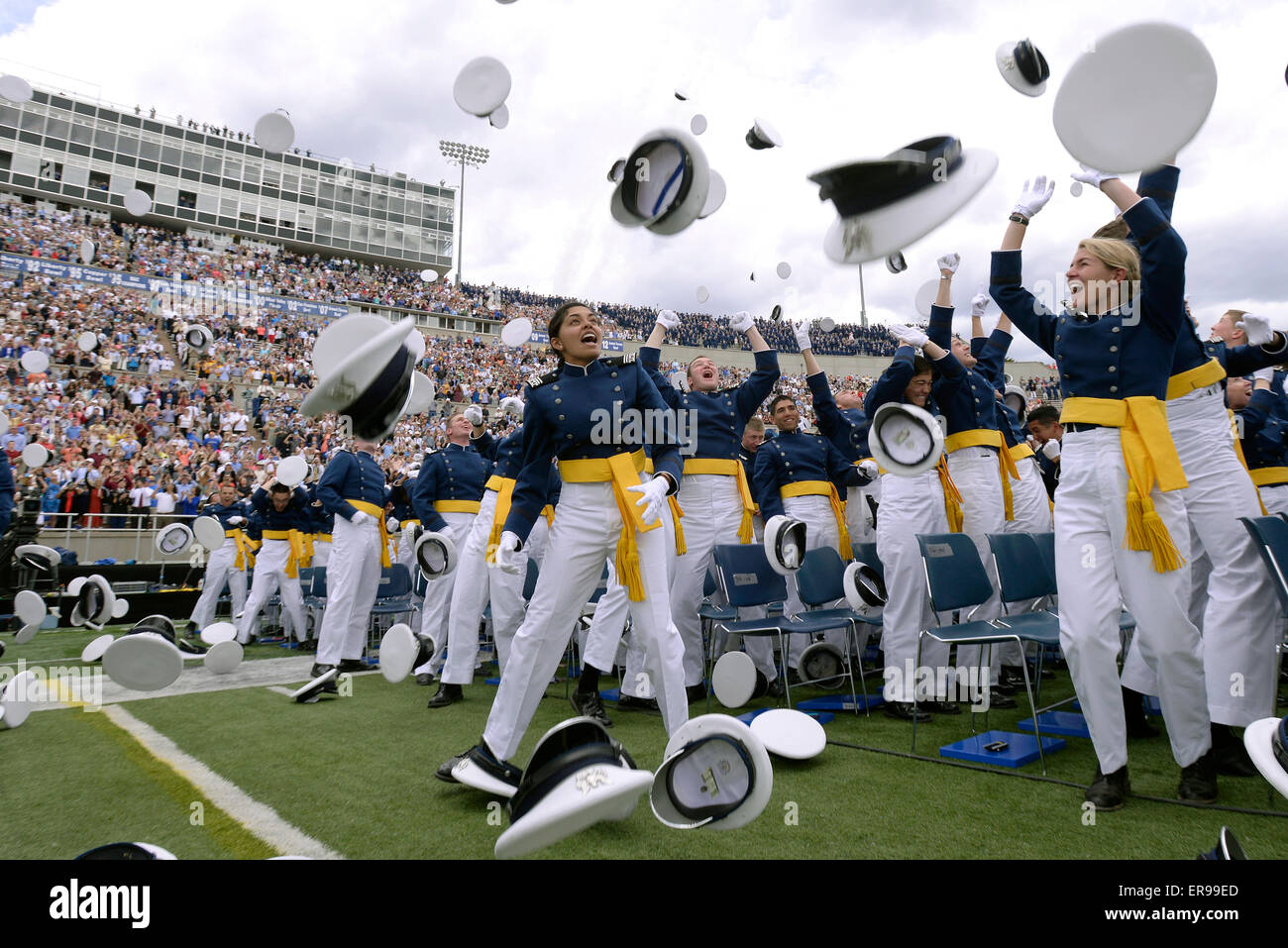 Cadets at the U.S. Air Force Academy Class of 2015 celebrate by throwing their hats into the air as the Thunderbirds fly overhead at the conclusion of commencement May 28, 2015 in Colorado Springs, Colorado. Stock Photo