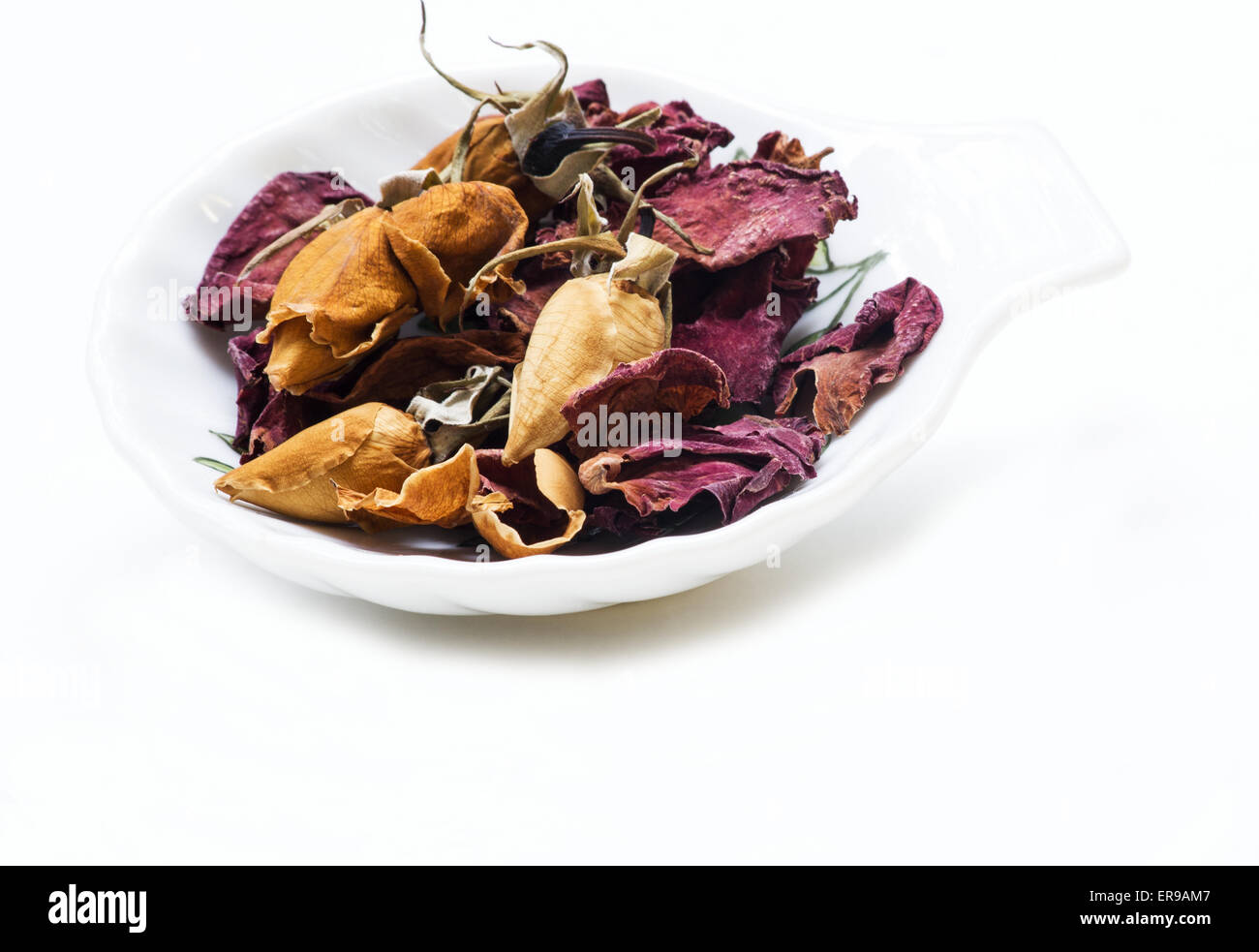 Dried rose buds and petals on white background Stock Photo