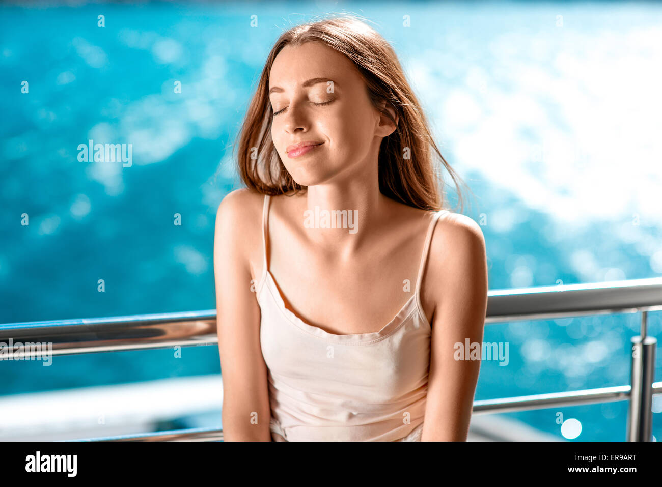 Young and pretty woman on the balcony Stock Photo