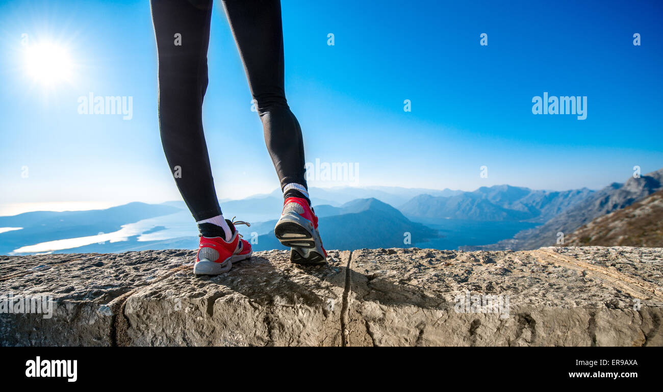 Sporty legs on the mountain hill Stock Photo