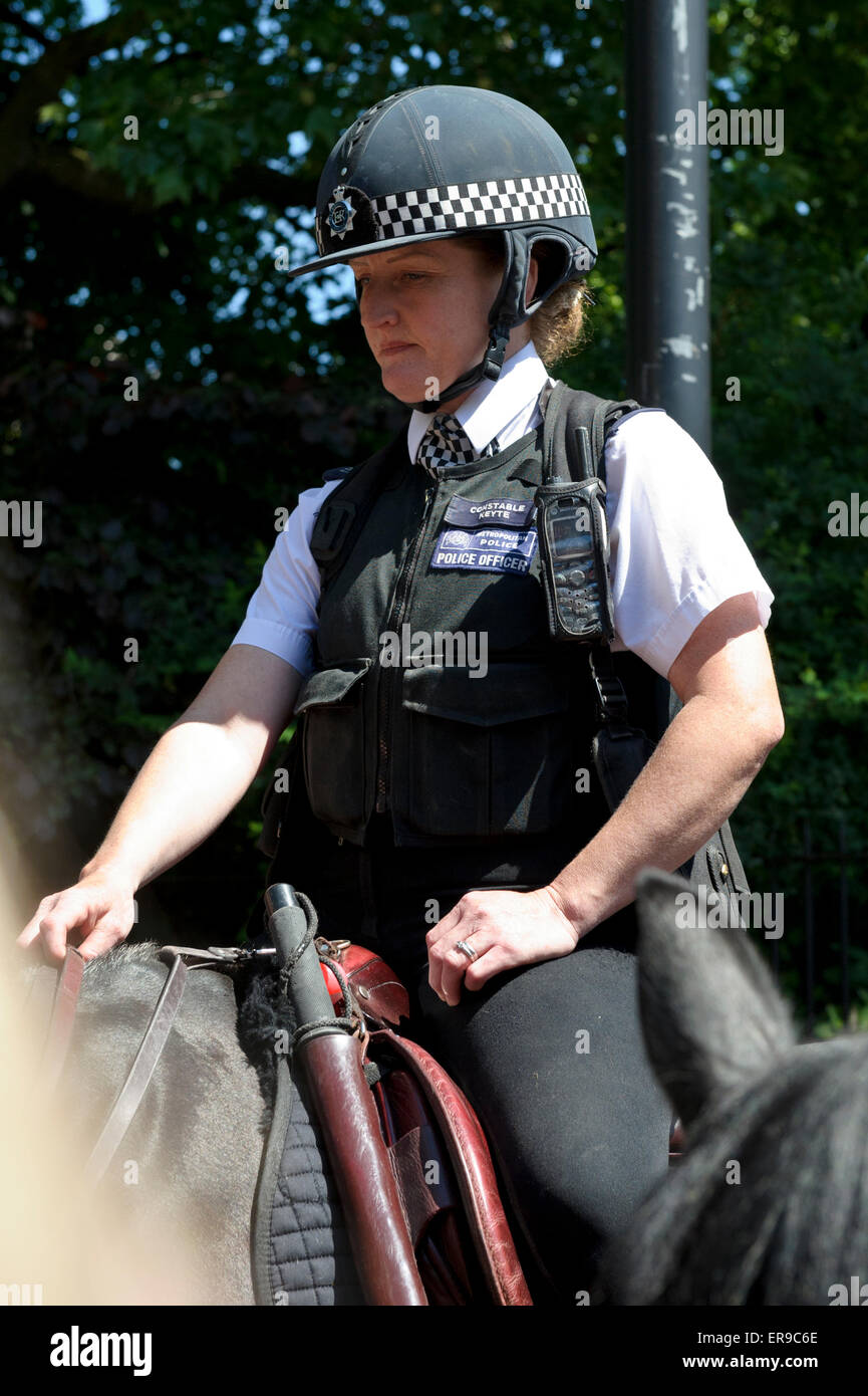 A uniformed female police officer on horse back on duty in London