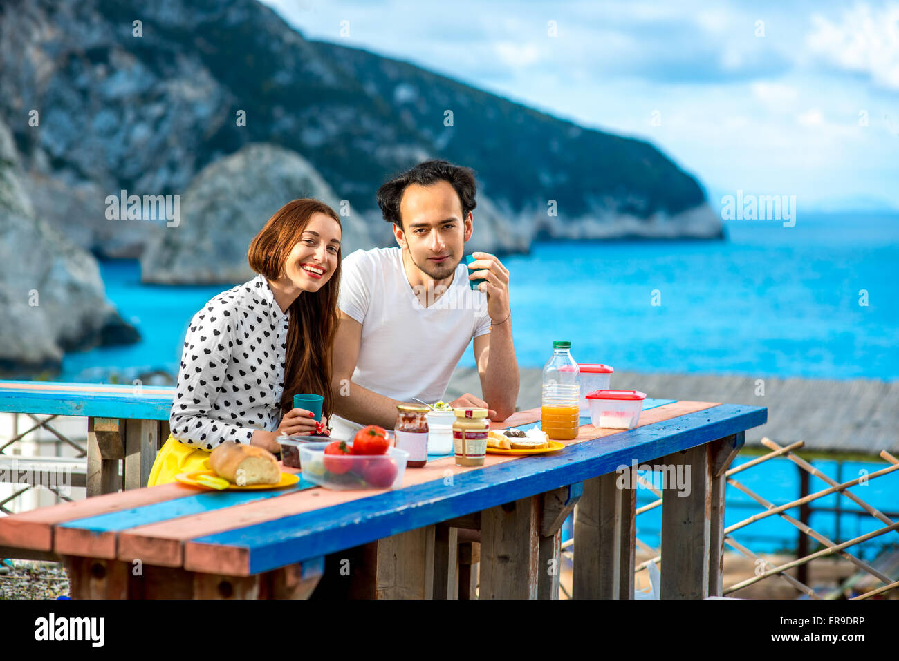 Young couple having breakfast outdoors Stock Photo