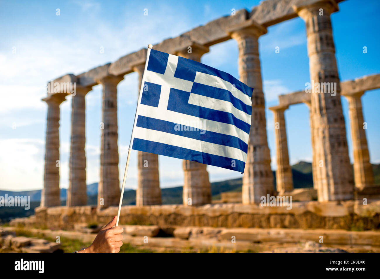 Greek flag on Poseidon temple background Stock Photo