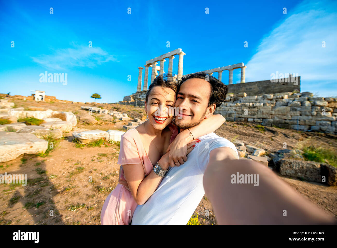 Tourist young couple near Poseidon temple in Greece Stock Photo