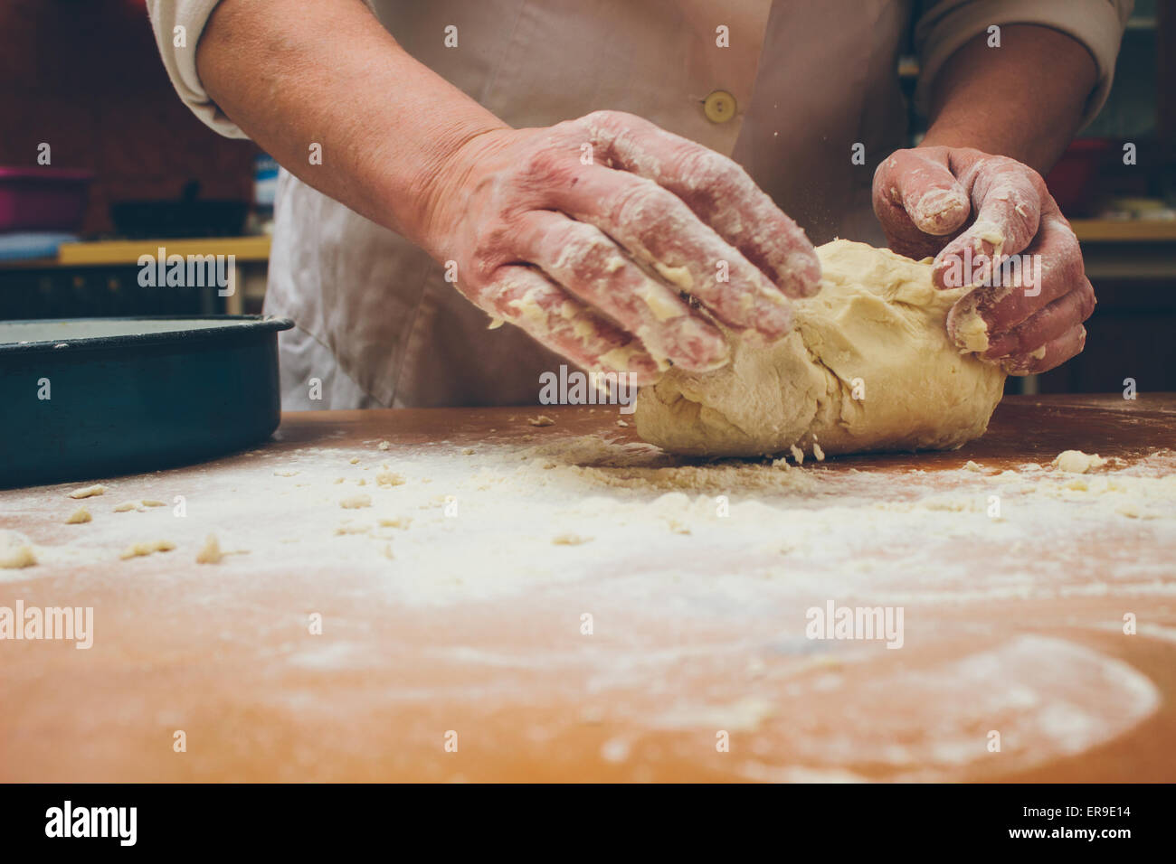Closeup photo of baker making yeast dough for bread. Retro styled ...