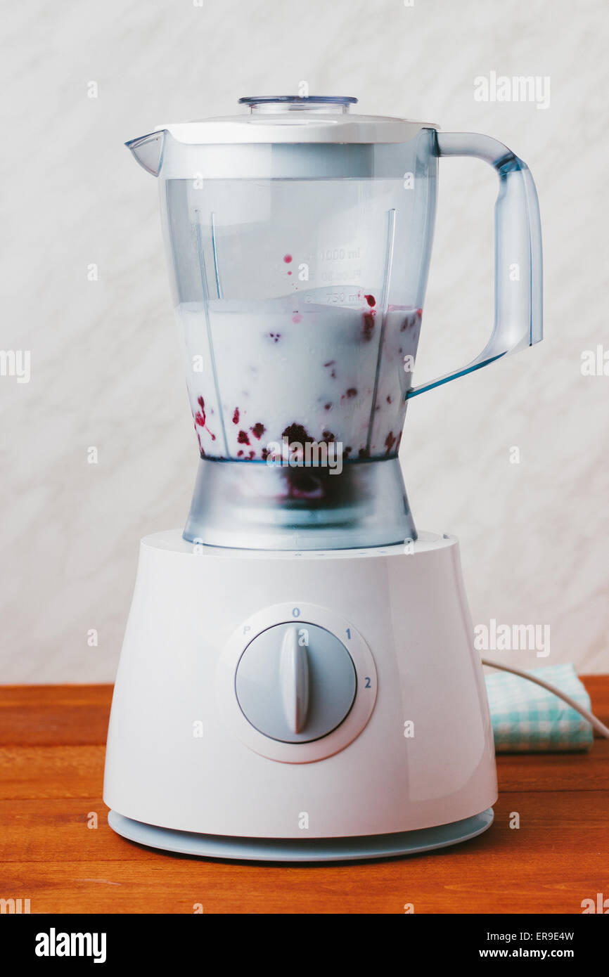 Raspberries and milk in a blender closeup, mixing healthy ingredients for  smoothie Stock Photo - Alamy