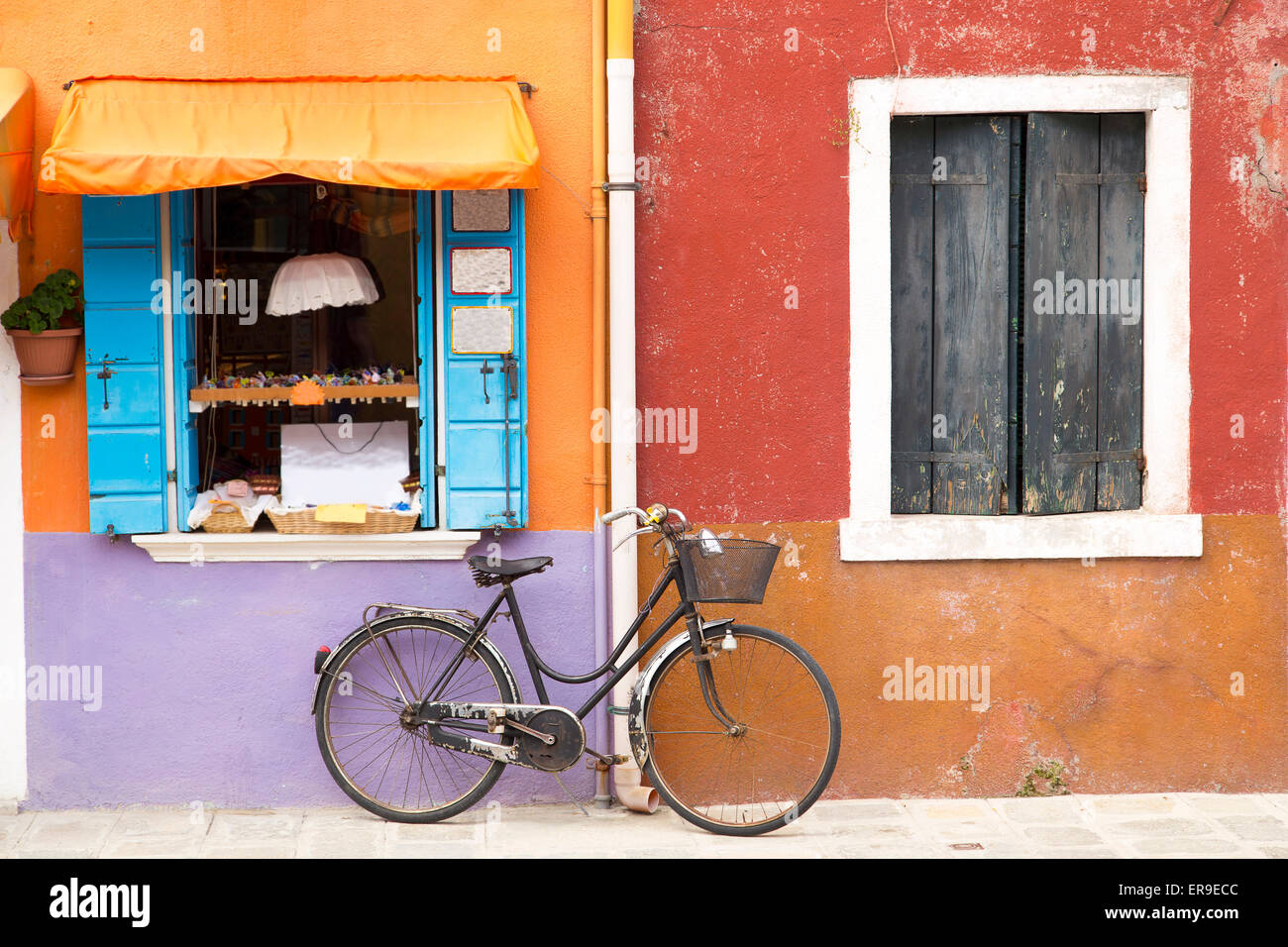 Colorful house on the island of Burano street with a bicycle near the window, Venice, Italy Stock Photo