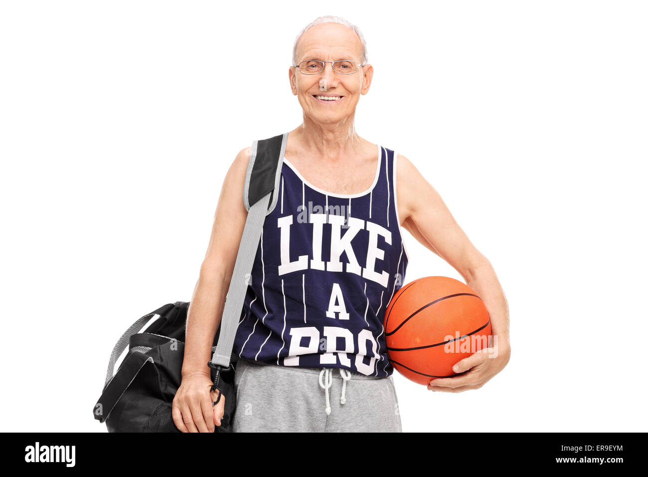 Senior man in sportswear holding a basketball and looking at the camera isolated on white background Stock Photo