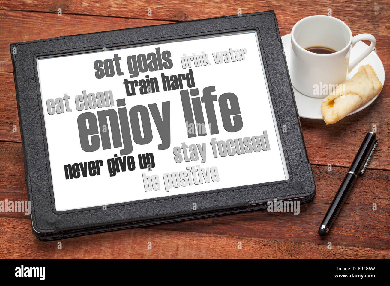 enjoy life - healthy lifestyle word cloud on a digital tablet with a cup of coffee Stock Photo