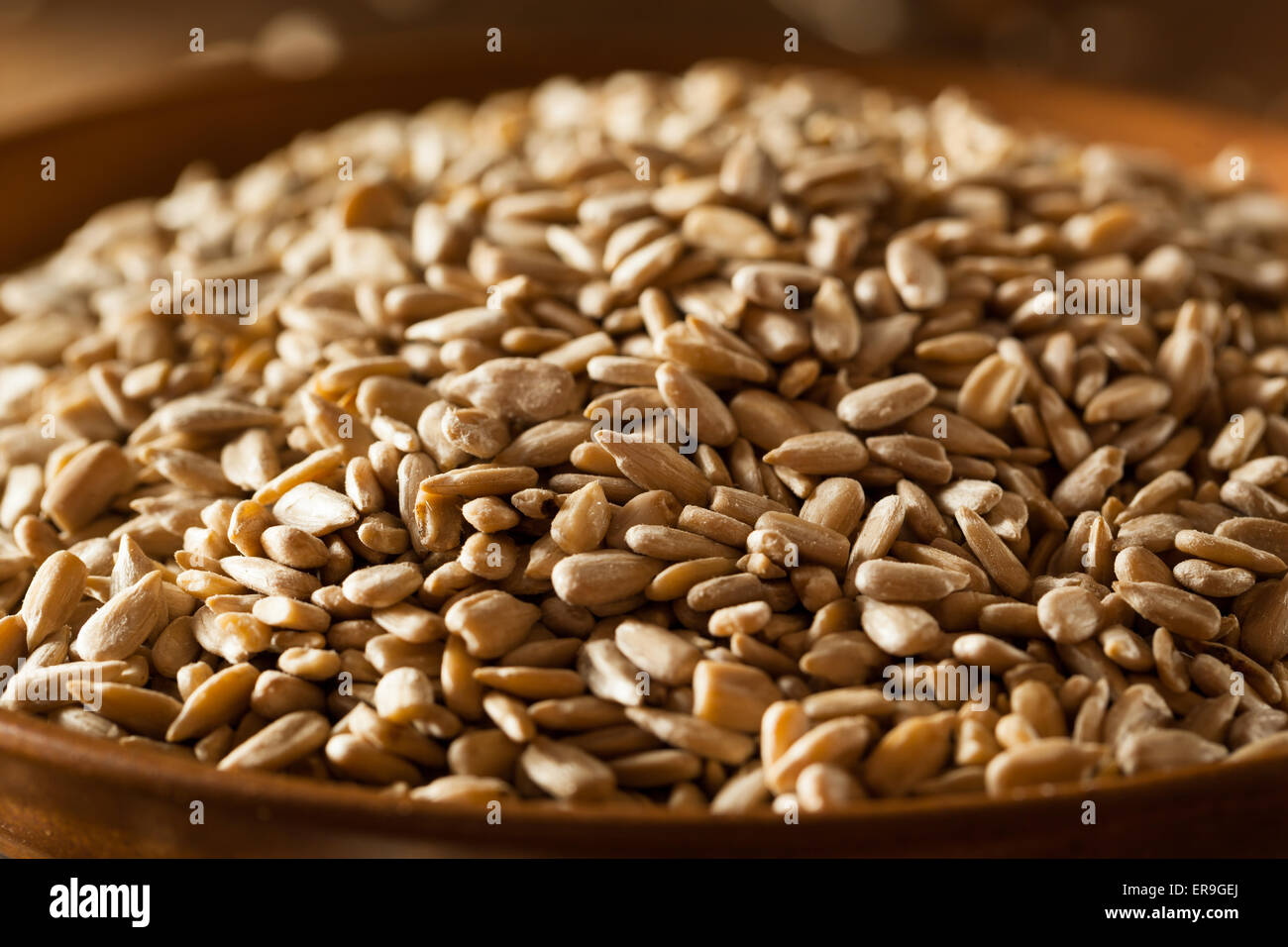 Raw Organic Hulled Sunflower Seeds in a Bowl Stock Photo