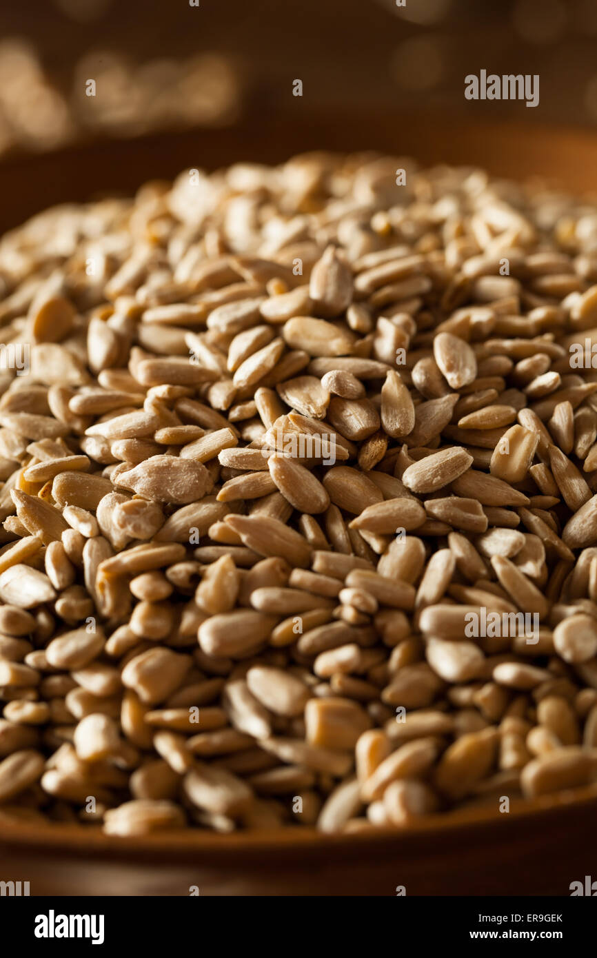 Raw Organic Hulled Sunflower Seeds in a Bowl Stock Photo