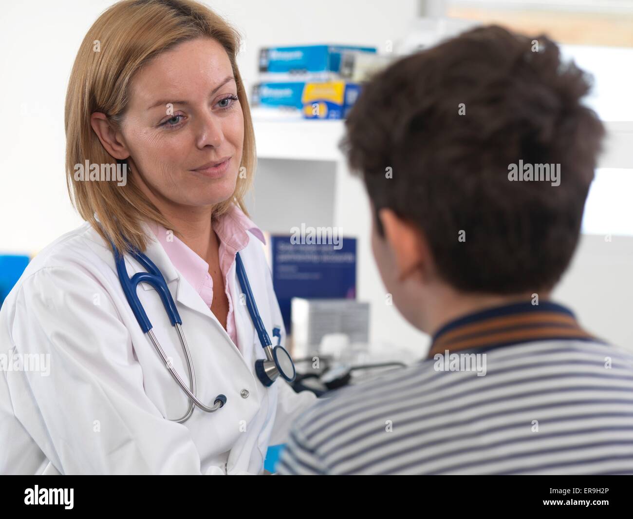 PROPERTY RELEASED. MODEL RELEASED. Doctor comforting a 10 year old boy in a clinic. Stock Photo