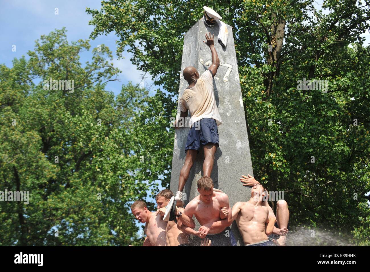 US Naval Academy freshmen known as plebes, climb the Herndon Monument