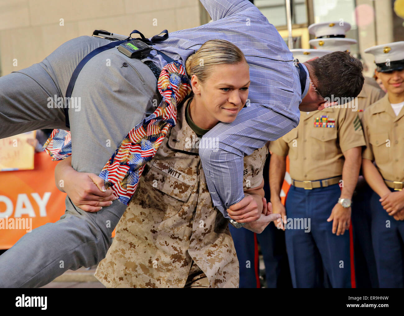 US Marine 1st Lt. Monica Witt carries MSNBC news anchor Thomas Roberts during the morning talk show Today as a part of Fleet Week May 23, 2015 in New York City, NY.  Marines showcase the capabilities of the Marine Corps both physically, mentally and technologically during Fleet Week New York. Stock Photo