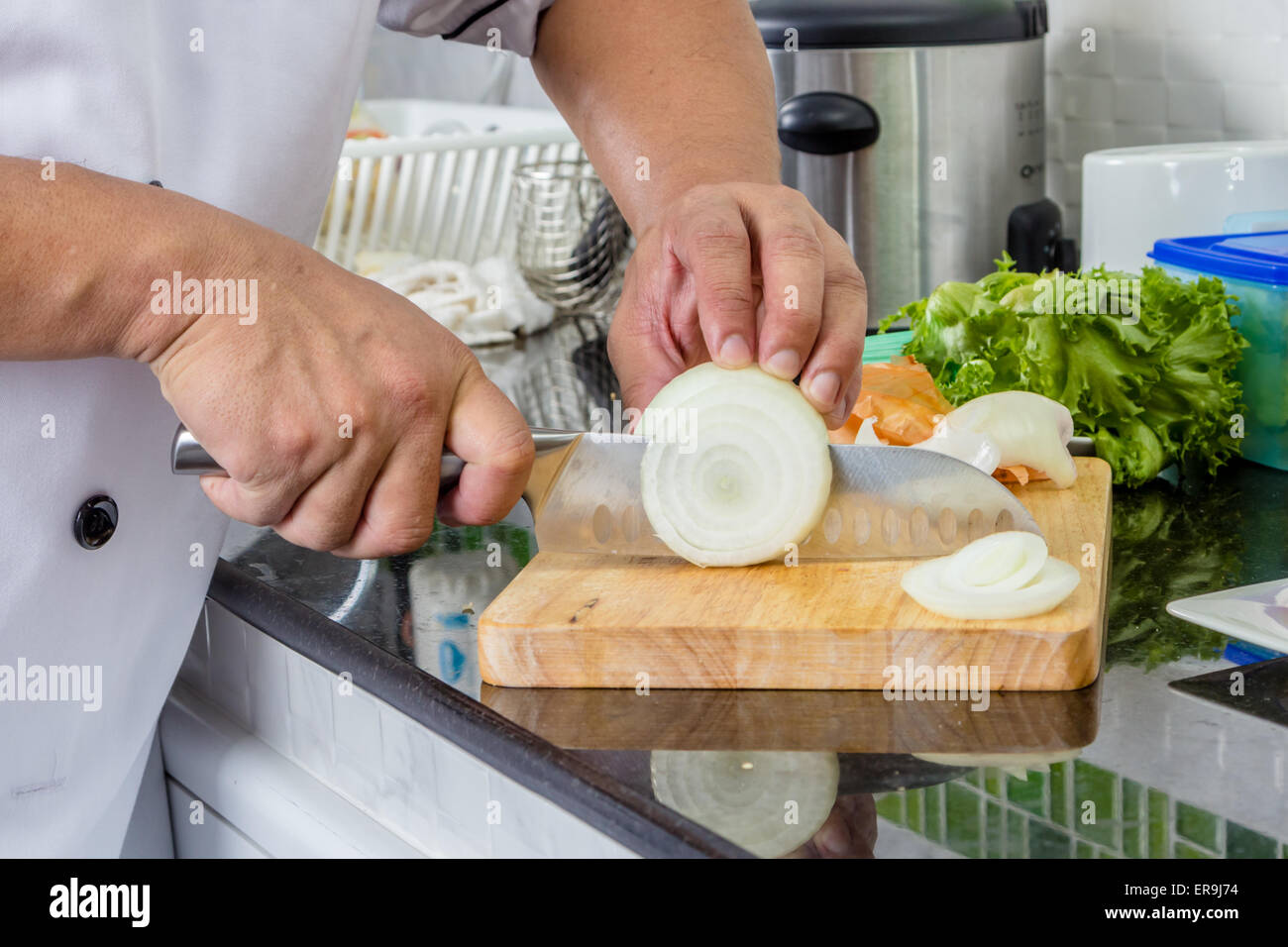Chef chopping onion on the cutting board Stock Photo - Alamy
