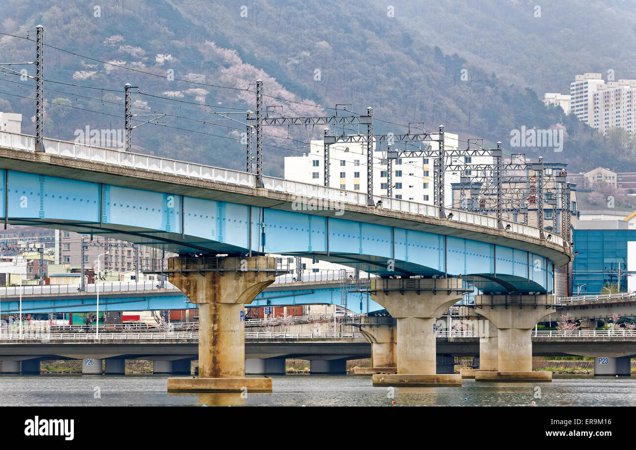 train bridge across river and city background at busan , korea Stock Photo