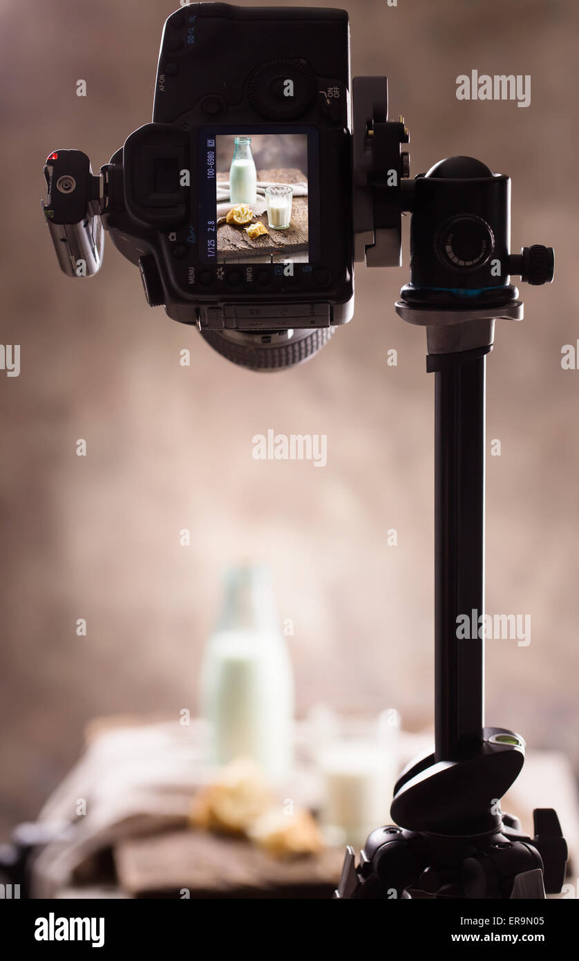 Photographing still-life with a bottle of milk with the help of the camera and tripod Stock Photo