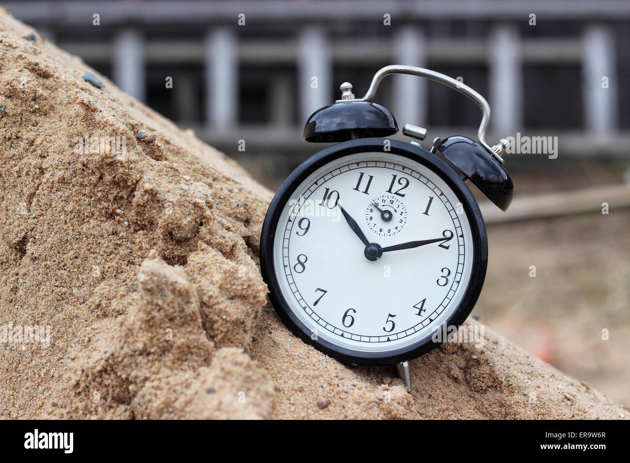 Vintage alarm clock on building background closeup Stock Photo - Alamy