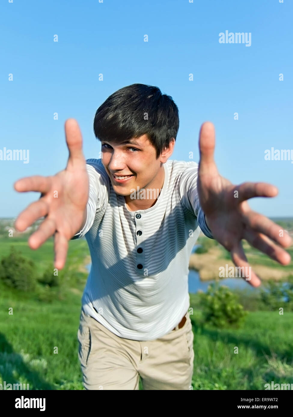 cheerful guy with outstretched arms outdoors Stock Photo