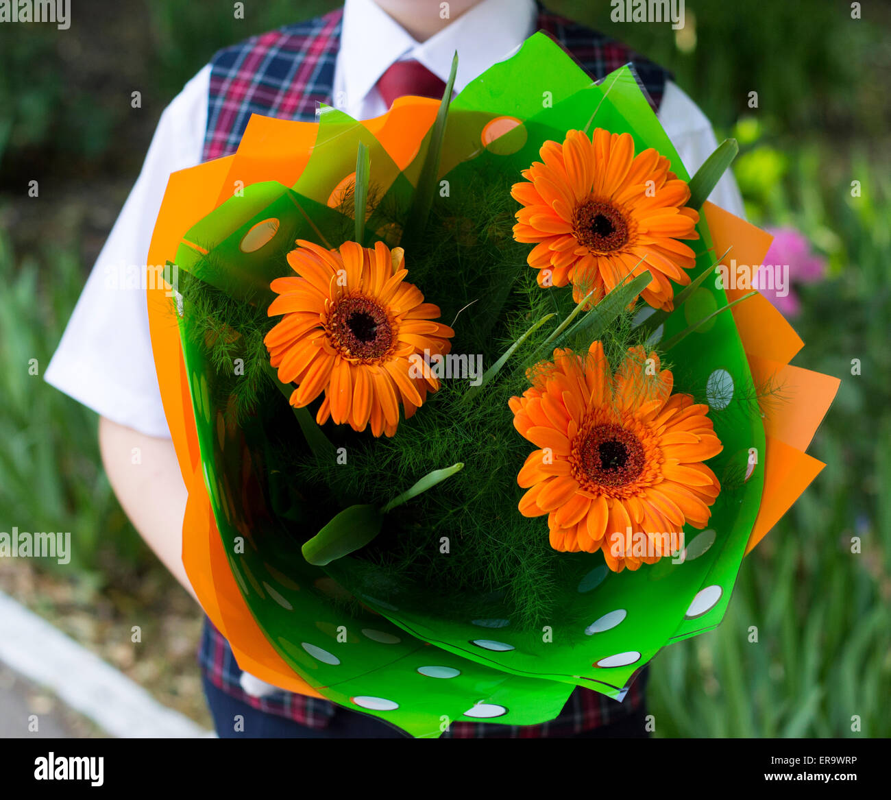 the school student with flowers, a close up, flowers in the center Stock Photo