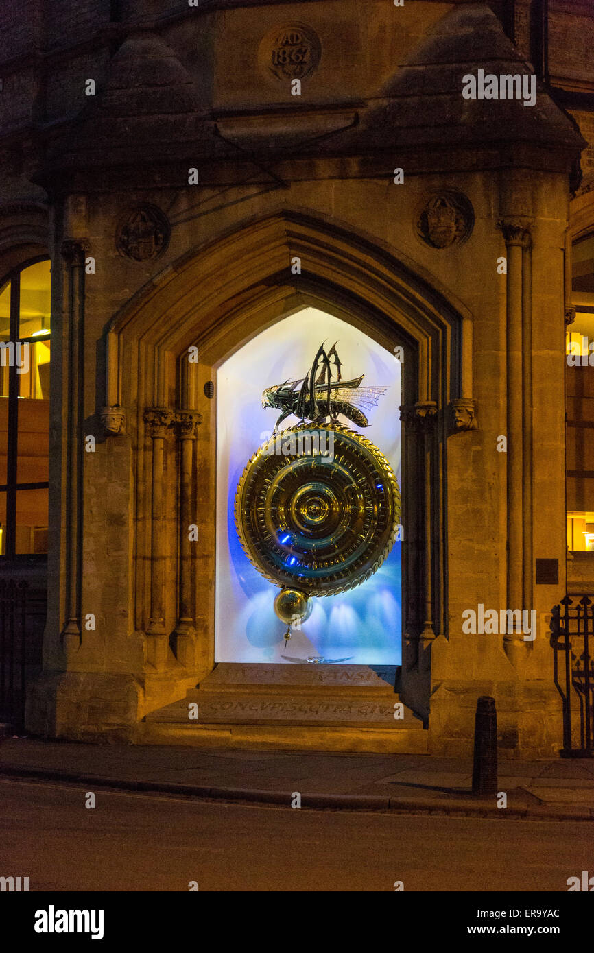 UK, England, Cambridge.  Corpus Clock, Corpus Christi College, Nightime Illumination.  'Chronophage' on top, 'eater of time.' Stock Photo