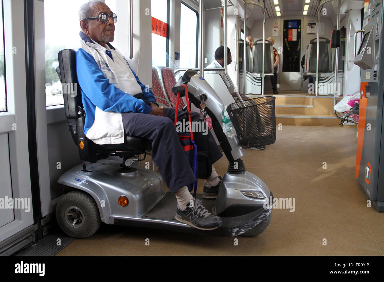Man on mobility scooter on train Stock Photo Alamy