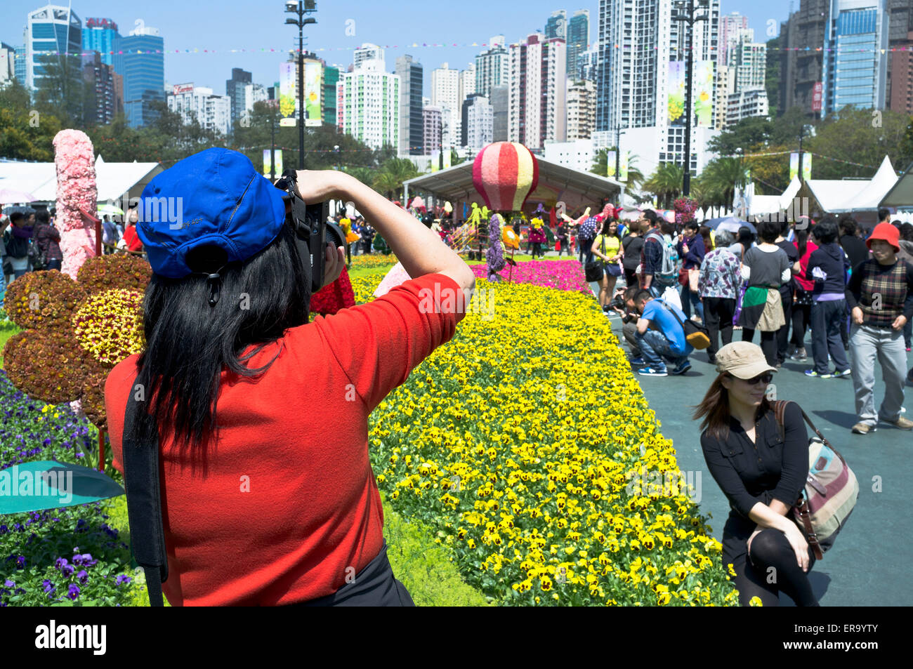 dh Victoria Park CAUSEWAY BAY HONG KONG Asian woman taking photograph at Hong Kong Flower Show female parks Stock Photo