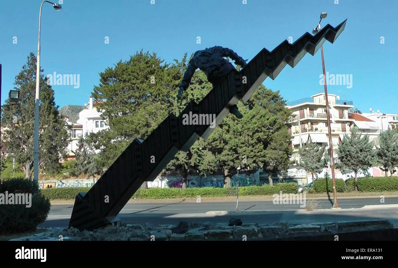 Athens. 14th May, 2015. Photo taken on May 14, 2015 shows a view of the sculpture 'Crisis' by 22-year-old Greek self-taught artist Tasos Nyfadopoulos in Athens, capital of Greece. Situated next to Vouliagmenis Avenue, a few kilometers from the center of Athens, the impressive sculpture, about 7 meters long and 4 meters high, is a giant stock exchange index that crushed on the ground and broke into pieces. On the top of it, a man is about to fall as the index collapses. © Athanasia Batziou/Xinhua/Alamy Live News Stock Photo