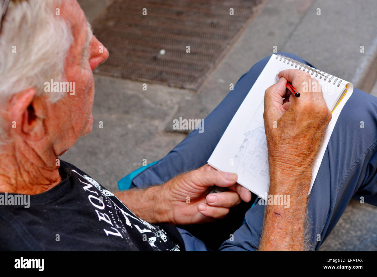 Tourist sketching in Plaza Mayor, Madrid, Spain Stock Photo