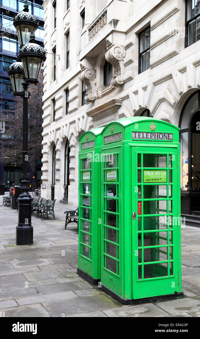 Green traditional British public telephone boxes in London, England