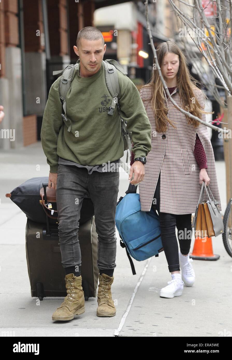 Shia LaBeouf and girlfriend Mia Goth leaving his hotel. Shia seen sporting  short cropped hair and scruffy clothing as he wheels his luggage out.  Featuring: Shia LaBeouf,Mia Goth Where: Manhattan, New York,