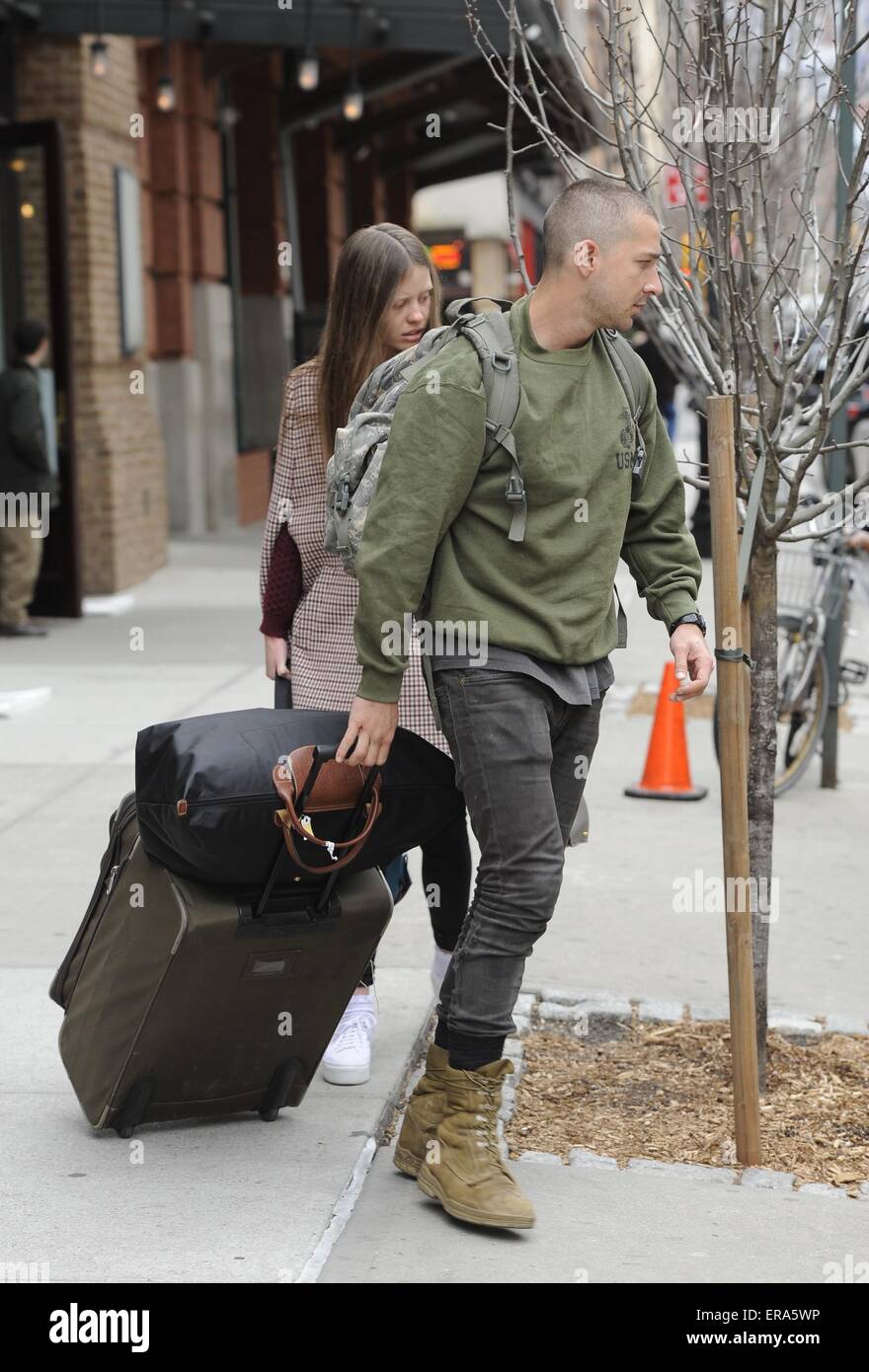Shia LaBeouf and girlfriend Mia Goth leaving his hotel. Shia seen sporting  short cropped hair and scruffy clothing as he wheels his luggage out.  Featuring: Shia LaBeouf, Mia Goth Where: Manhattan, New