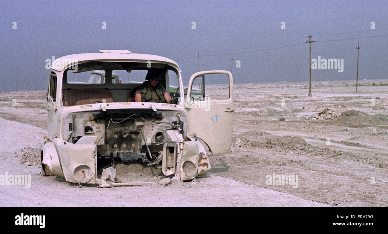 2nd April 1991 Near the ancient city of Ur in southern Iraq, a US soldier grabs some sleep in a wrecked Iraqi Army truck. Stock Photo
