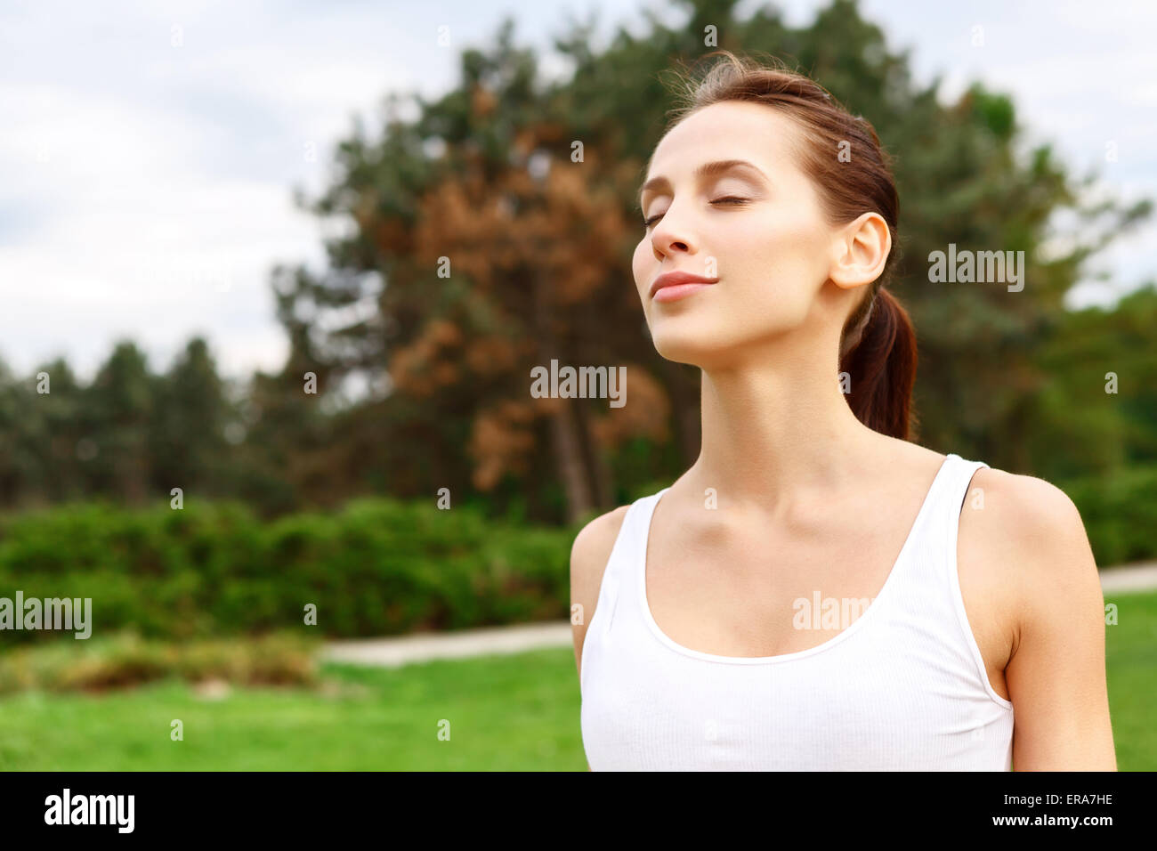 Pretty girl with closed eyes in park Stock Photo - Alamy